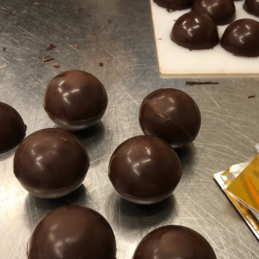 Chocolate truffles on a metal surface